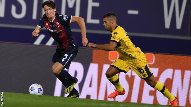 Bologna's Aaron Hickey is chased by Parma's Vincent Laurini