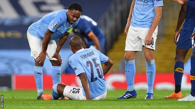 Fernandinho is injured during Manchester City's Champions League group game with Porto