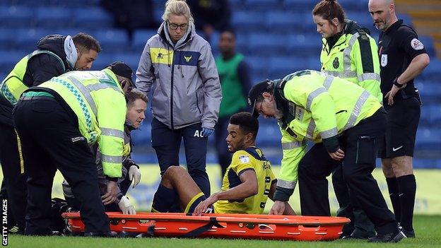 Oxford United captain Curtis Nelson stretchered off against Northampton Town