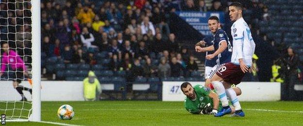 John McGinn gets the faintest of touches on Ryan Christie's shot to open the scoring