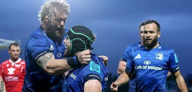 Caelan Doris celebrates with team-mates having scored Leinster's fourth try against Scarets