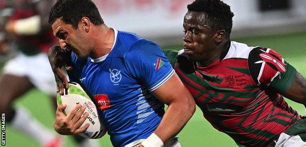 Namibia full-back Divan Rossouw is tackled by Kenya centre John Okoth Okeyo