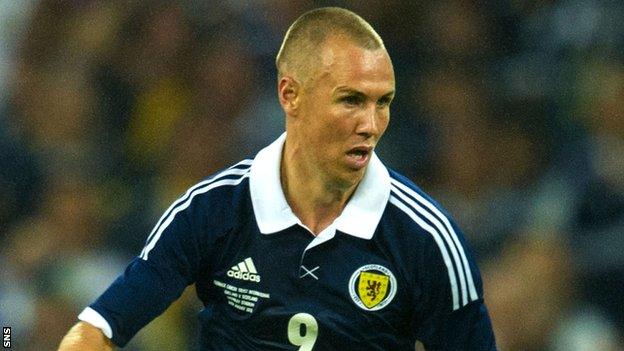 Kenny Miller in action for Scotland against England in 2013