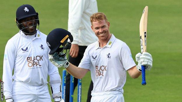 Kent batter Ben Compton (right)celebrates scoring a century