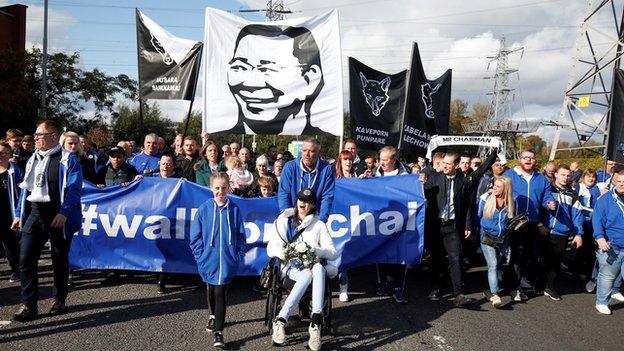 Fans walk in memory of the late chairman