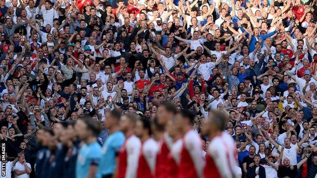 England and Denmark players line up for the national anthems