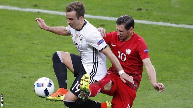 Poland's Grzegorz Krychowiak (right) in action with Germany's Mario Gotze