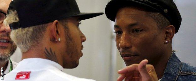 Mercedes driver Lewis Hamilton (left) talks to singer Pharrell Williams during the Singapore Grand Prix second practice session