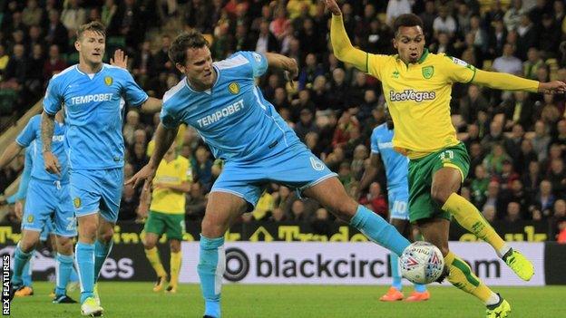 Norwich City midfielder Josh Murphy (11) battles for the ball with Burton Albion defender Ben Turner