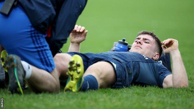 Luke McGrath gets treatment during Leinster's win over Toulouse before hobbling off