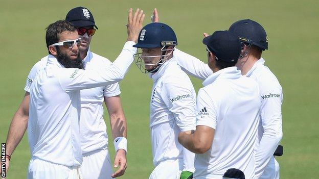 Moeen Ali (left) celebrates a wicket