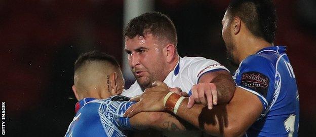 Greece back-rower Billy Magoulias is tackled by two Samoa players