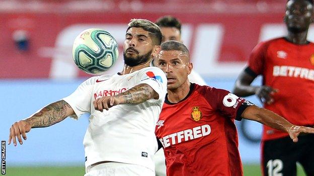 Ever Banega (left) in action for Sevilla against Mallorca