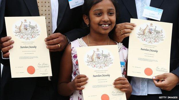 A young girl receives her Australian citizenship at a ceremony