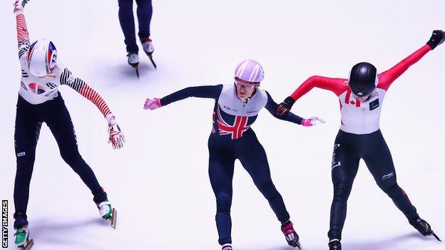 Elise Christie crosses the line to win 1000m world championship gold