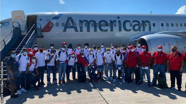 The Belize team posing outside an airplane before flying to Haiti