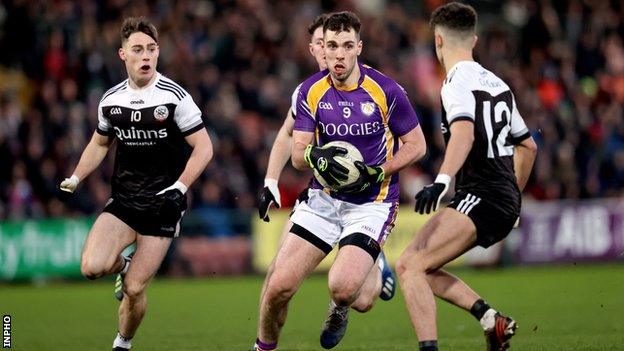 Derrygonnelly's Ryan Jones is surrounded by opponents at the Athletic Grounds