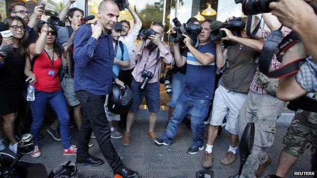 Yanis Varoufakis surrounded by media