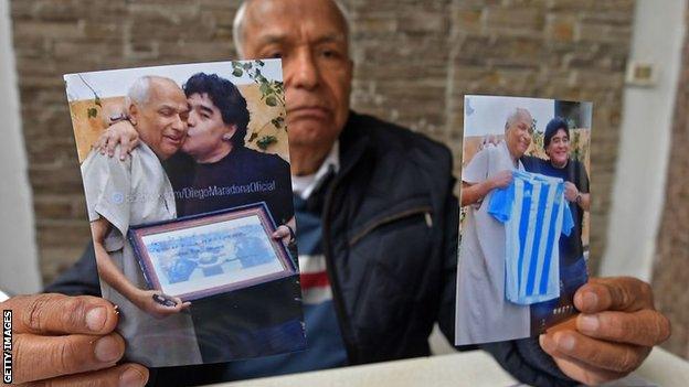 Former referee Ali Bin Nasser with his photographs of Maradona