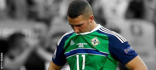 Conor Washington looks dejected after Northern Ireland's defeat by Poland