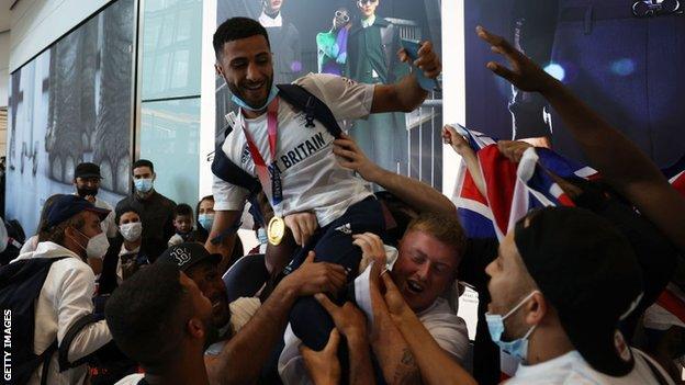 Boxer Galal Yafai is congratulated at Heathrow Airport.