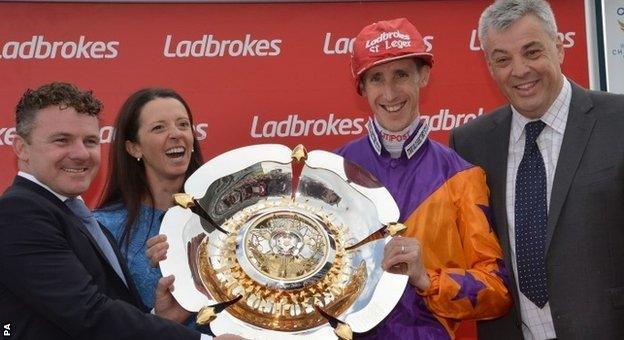 Trainer Laura Mongan and jockey George Baker (centre) celebrate after St Leger win