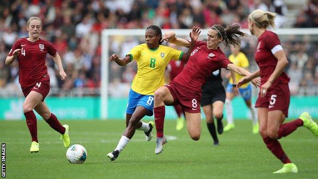 Mota Miraildes of Brazil vies with Jill Scott of England