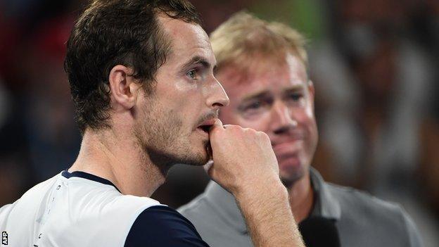 Andy Murray watches the video montage of messages from current tennis players on court at the Melbourne Arena