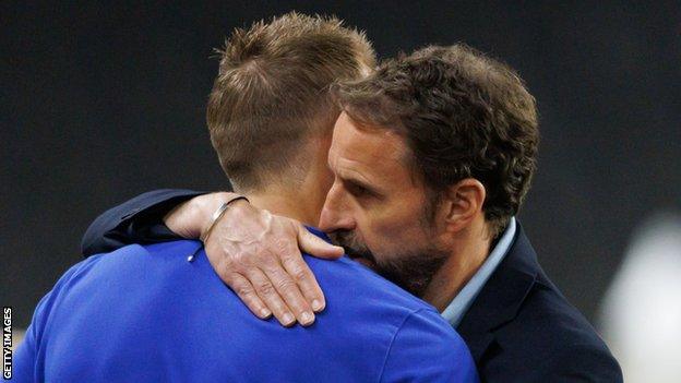 England manager Gareth Southgate hugging Harry Kane