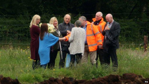 Relatives of Seamus Wright meet investigators at the scene