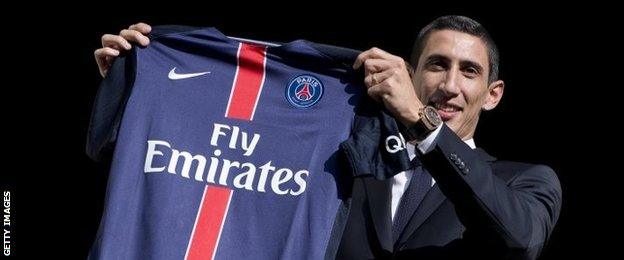 Angel Di Maria with a PSG shirt after signing