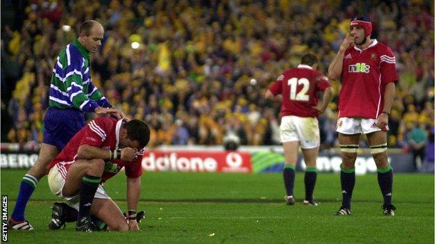 Martin Johnson is dejected on the floor and the referee consoles him
