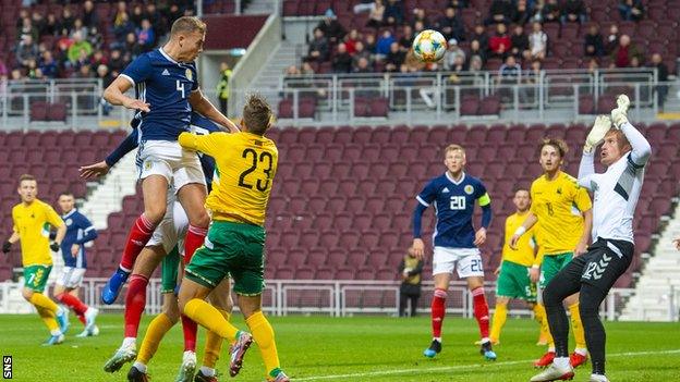 Ryan Porteous heads the ball for Scotland Under-21s against Lithuania