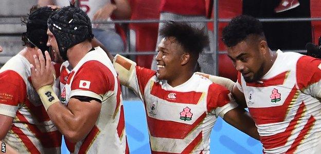 Kotaro Matsushima (centre) celebrates after scoring a try against Samoa