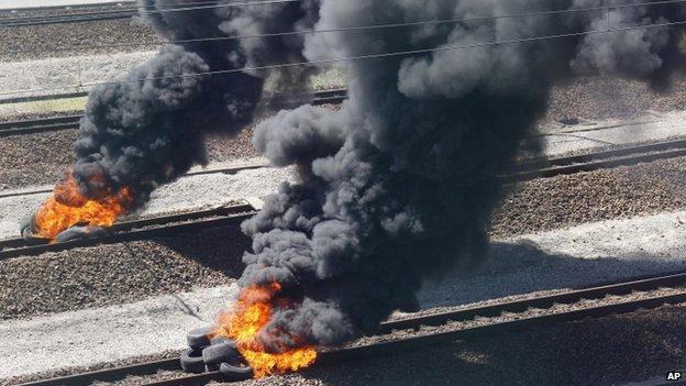 Burning tyres on Eurotunnel tracks near Calais