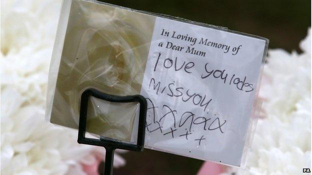 A note attached to a floral tribute left at the grave