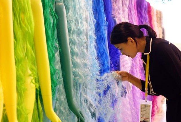 A woman looking at wigs in Henan