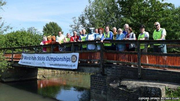 Organisers of the pooh sticks championships pose on the bridge