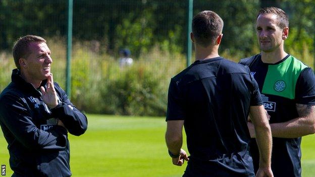 Brendan Rodgers chats with assistants John Kennedy (centre) and Chris Davies (right)