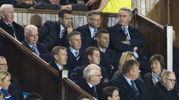 Rangers manager Pedro Caixinha sits in the stand, surrounded by the club's directors