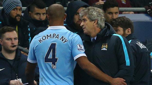 Vincent Kompany is consoled by Manuel Pellegrini