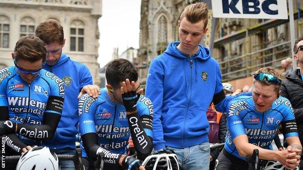 Veranda's Willems-Crelan riders are comforted during a minute's silence to remember Michael Goolaerts