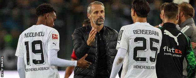 Head coach Marco Rose of RB Leipzig and Ramy Bensebaini of Borussia Moenchengladbach gestures after the Bundesliga match between Borussia Mönchengladbach and RB Leipzig at Borussia-Park