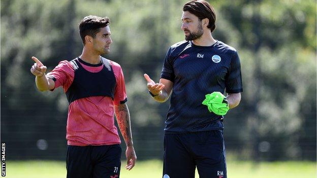 Russell Martin, pictured here with midfielder Yan Dhanda (left), has had only a handful of training sessions to prepare for Saturday's game at Blackburn
