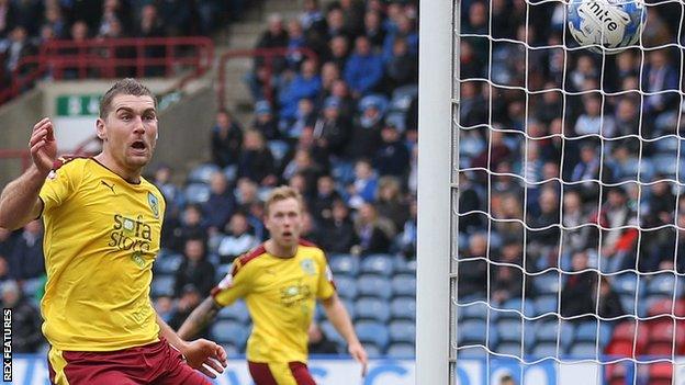 Sam Vokes watches as his the ball goes in off the post for Burnley's second against Huddersfield