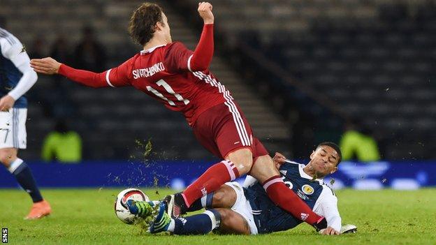 Denmark's Erik Sviatchenko is tackled by Scotland's Liam Bridcutt