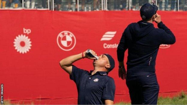 Justin Thomas and Thomas Berger drinking beers on the first tee at Whistling Straits