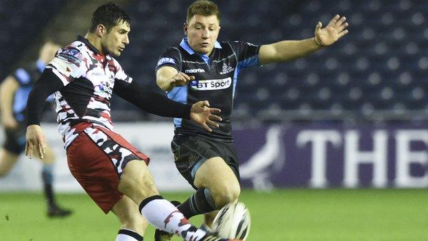 Edinburgh's Phil Burleigh (left) is closed down by Duncan Weir