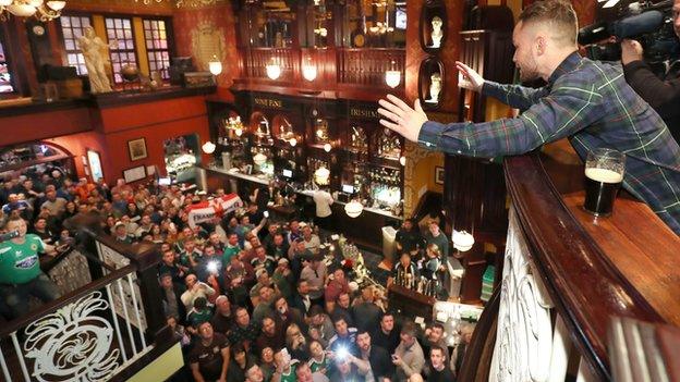 Carl Frampton acknowledges his fans at the Nine Fine Irishmen bar, where he bought them all a drink