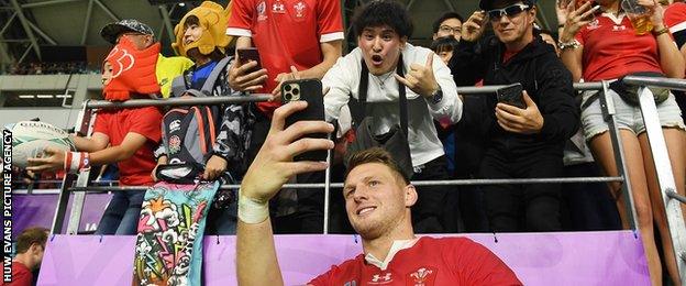 Dan Biggar takes a selfie with fans after Wales' World Cup quarter final win against France